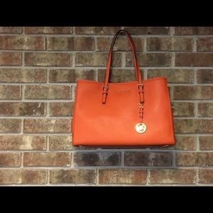 Micheal Kors orange leather purse.